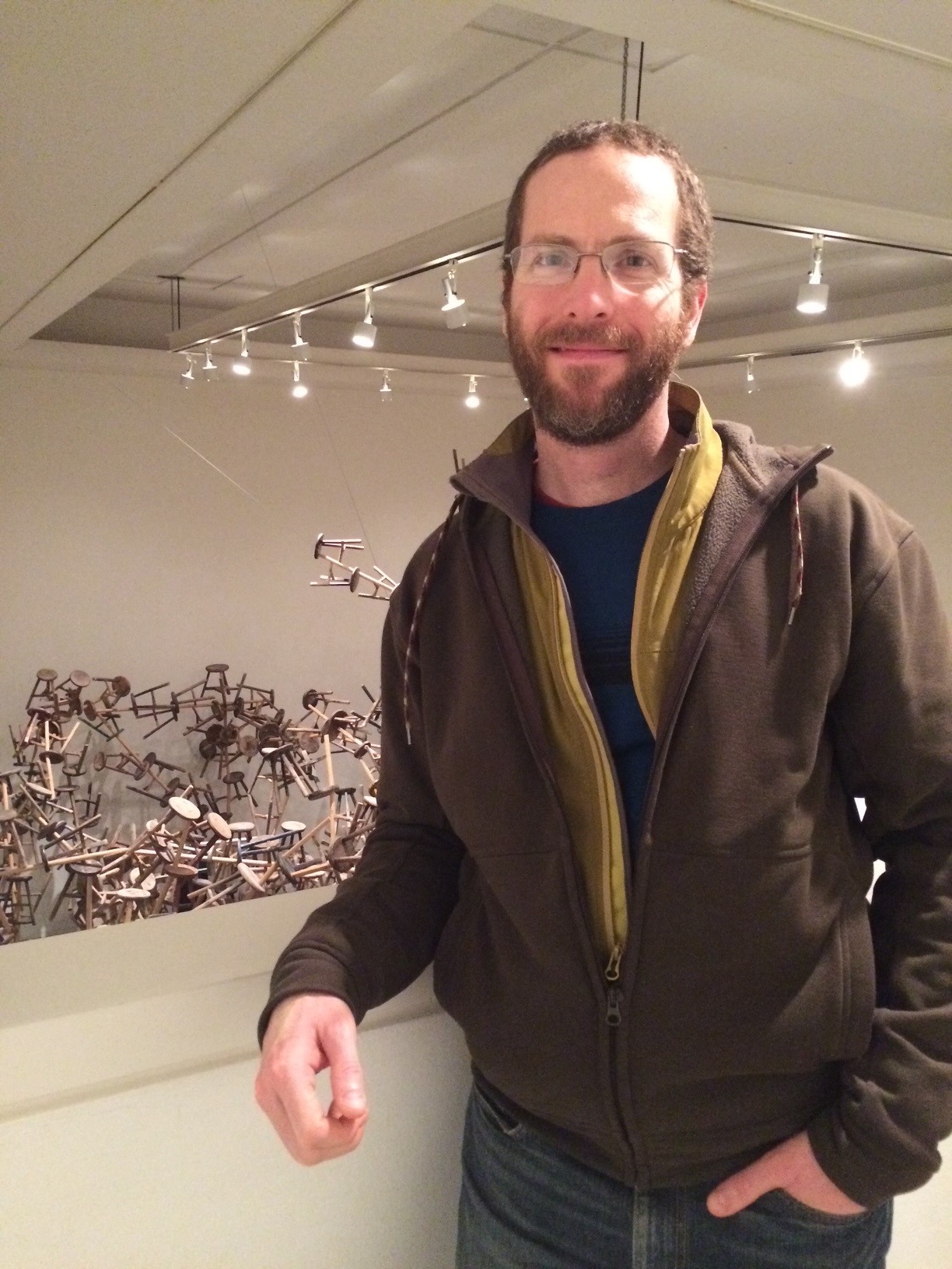 Photo headshot of smiling man with beard and glasses. 